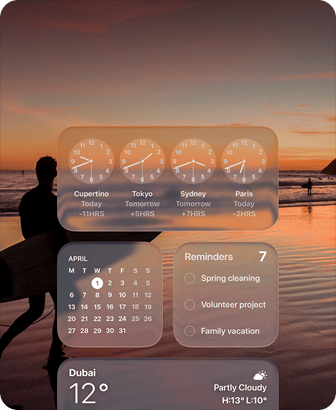 Liquid Glass Clock, Calendar, Reminders, and Weather widgets on macOS Tahoe screen over a scene of a surfer walking on the beach at sunset
