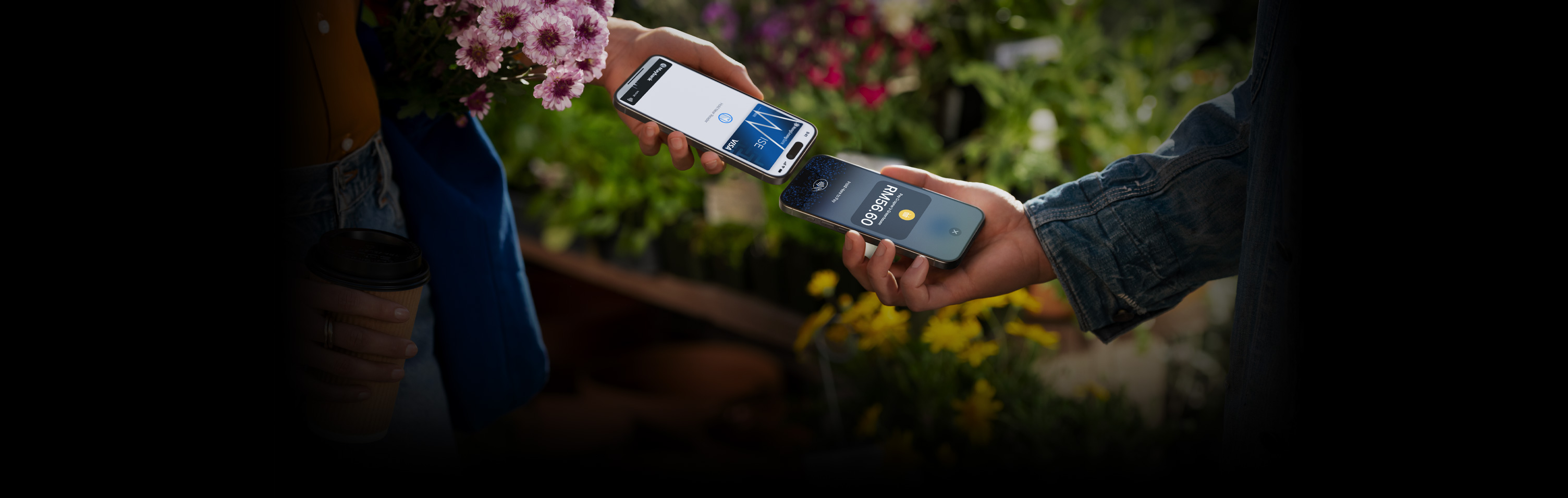 An image of two people holding their iPhone devices together completing a transaction.
