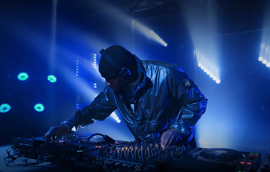 A DJ performing at a live music concert.