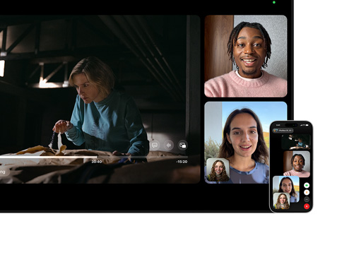 Mac and iPhone: SharePlay split view on Mac, Apple TV show plays on left, FaceTime tiles on right show three people, iPhone mounted beside Mac used as Continuity Camera