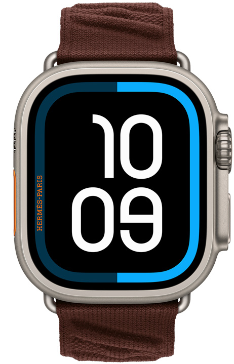 Apple Watch Hermès Ultra 4, esfera digital Maritime, caja de titanio, color natural, lateral derecho, Digital Crown, botón lateral elevado, con la correa En Mer, color Bordeaux (marrón oscuro), en tejido en relieve