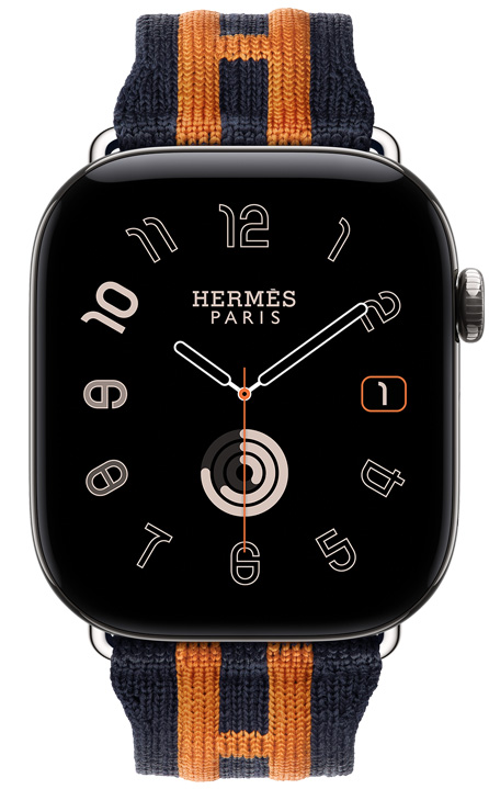 Apple Watch Hermès Series 12, esfera analógica Radial, (aguja horaria, minutero y segundero, complicaciones: fecha, anillos de Actividad), caja de titanio, color plata, lateral derecho, Digital Crown, botón lateral elevado, con la correa Rocabar Club, color Bleu Nuit/Orange, en tejido azul oscuro con diseño de rayas naranjas en relieve que incorpora la H de Hermès