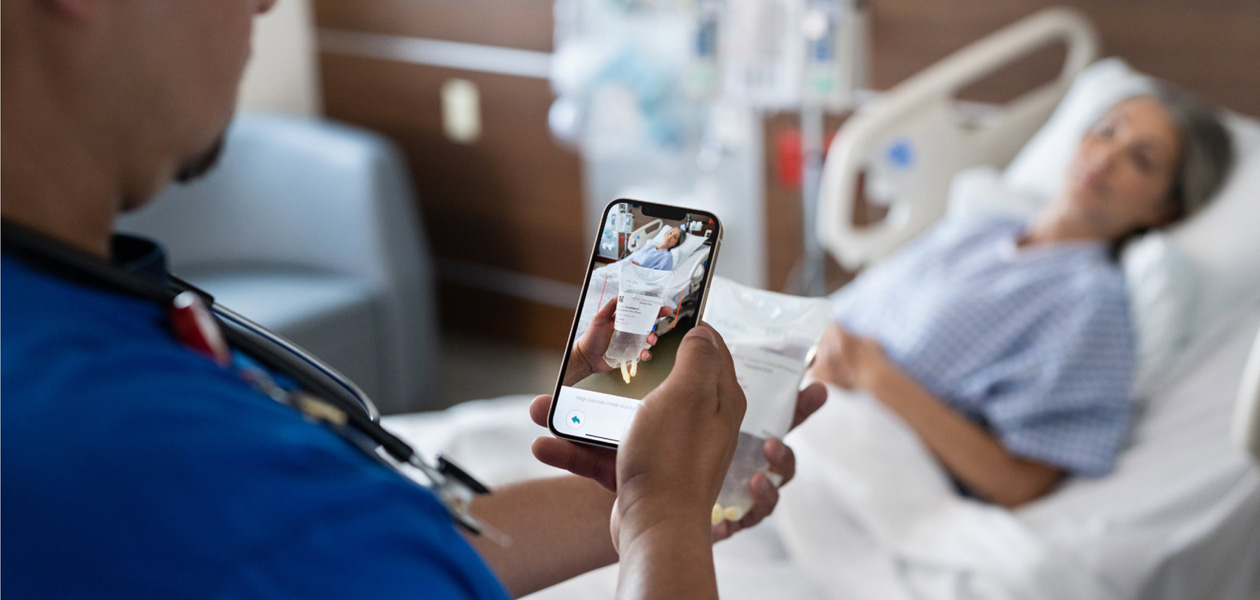 A nurse scans a patient's medication.