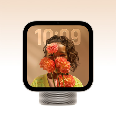 Apple HomeView, starlight color (pale gold), screen shows time over a wallpaper of a person holding flowers