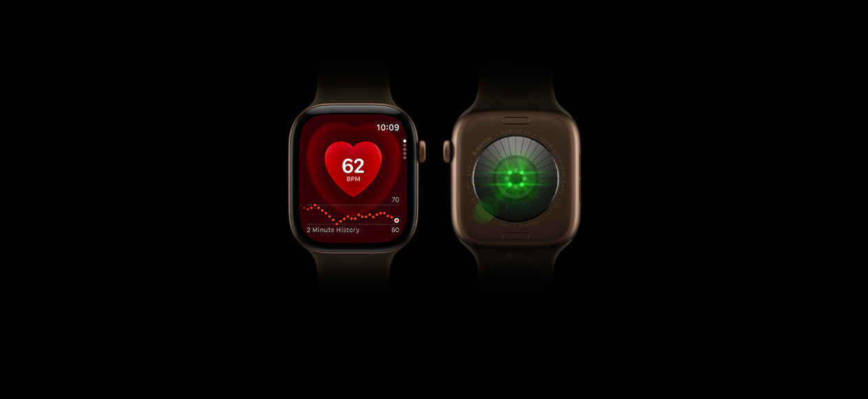 TTwo Apple Watch Series 12 devices, aluminium case, dark bronze colour, olive Sport Band, one showing front of watch with Heart Rate app, one showing back of watch with Health Sensing System with glowing green LED lights
