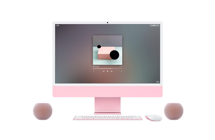 Pink iMac, front exterior, Apple Music playing on screen, colour-matched Magic Keyboard and Magic Mouse, flanked by two pink HomePod mini 2 speakers in a stereo pair setup